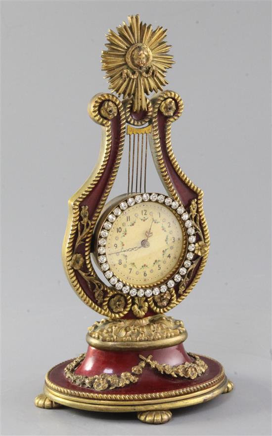 A French enamelled gilt metal lyre shaped timepiece, 22cm